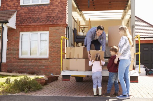 Moving van and helper preparing for a relocation job