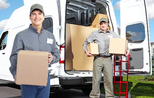 Boxes and furniture arranged in a new Croydon home after removal
