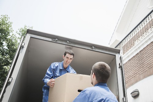 Professional movers carrying boxes during a local house relocation